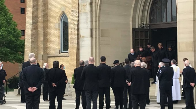 People Dressed In Black Outside Of A Church