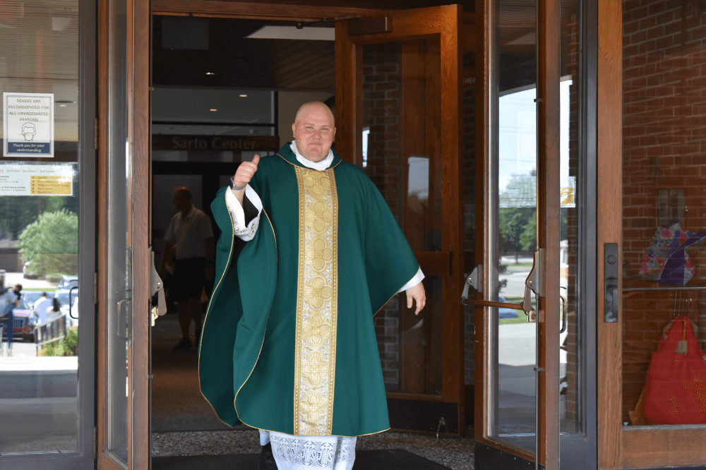 Fr. Durkee Pastor exits the church with a thumbs up.